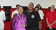 Anthony Arnett gives William Cheung one of his gold medals in Jacksonville
