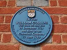 Blue Plaque on the wall of 21 East Street, Chichester PO19 1HP (a branch of the Halifax Bank in August 2022), commemorating William Collin's birth in an earlier building on the site and his death in the Cathedral Cloisters.