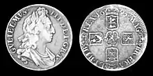 A silver coin picturing William III and his coat of arms