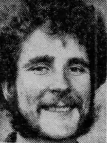 Photo of William Everett Woods in 1974. He is facing the camera and has curly hair and a beard.