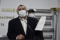 Wilson Santamaría holds up a document during a press conference.