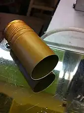 A screw cap capsule is fitted onto a wine bottle and heat shrunk tightly