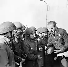 Pickard examines a German helmet taken after the raid