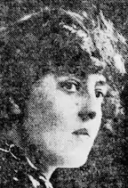 A black-and-white newspaper photograph of a young white woman, in 3/4 profile.