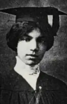 A young Black woman wearing academic cap and gown