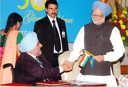 Ahluwalia with former Prime Minister of India - Manmohan Singh.