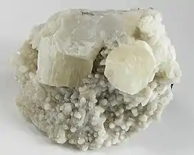 Two sharp pseudohexagonal crystals of witherite on calcite from Hardin County, Illinois (size: 6.4 x 5.4 x 3.4 cm)