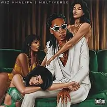 A drawing of the artist in a white suit sat on a green couch with three scantily-clad women embracing him.