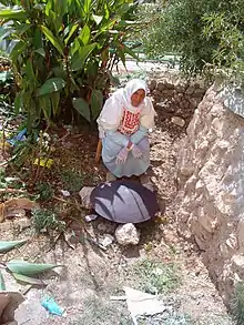 A Palestinian  woman baking markook on a saj in a West Bank village