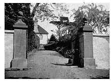 Woodway House with its granite gateposts and the cast-iron gates which survived being cut up during WW2.