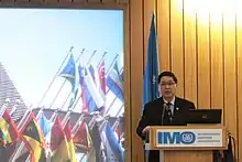 Photograph of Lam Yi Young speaking at the World Maritime Day Symposium at the International Maritime Organisation headquarters in London.