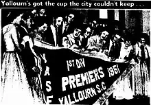 Yallourn Soccer Club holding the pennant for winning the 1951 Victoria State Championship