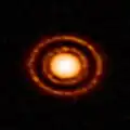 Protoplanetary disc AS 209 nestled in the young Ophiuchus star-forming region.