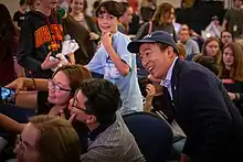 Yang posing for a selfie with two supporters.