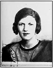 French identity card photo of Zelda Fitzgerald. She is facing the camera, and the picture has been stamped in the lower left corner. Zelda is wearing a mink coat and has uncharacteristically dark hair.