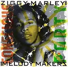 A black-and-white photo of Ziggy Marley with a yellow eye superimposed over it. The band's name is on the top and bottom of the photo and the album title is written sideways, colored in black, red and green respectively.
