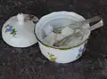 Sugar tongs in a sugar bowl