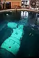 Cosmonauts training with the Zarya training module in the neutral buoyancy pool of the GCTC