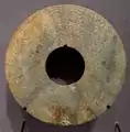 A Western Han dynasty green jade Bi disk, with dragon designs