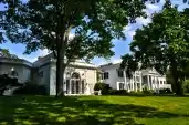 Rear elevation, classically ornate side of the two-story white house