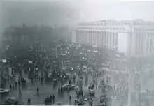 Demonstration in front of large, square building