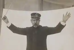 Black and white photograph of John Philip Sousa holding baton in a hand.