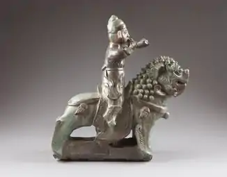 A horn blower riding a guardian lion, Qing dynasty