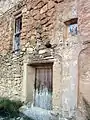 Estación X del Viacrucis de Val de la Sabina, Ademuz (Valencia): Detalle de ubicación en hornacina y pilastra de fachada.