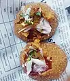 A Bangladeshi fuchka type bhelpuri  served on bengali newspaper