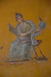 Fresco que representa a Urania, musa de la astronomía, con un globo terraqueo en la casa de Julia Felix, Pompeya.