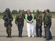 La Policía Nacional de Colombia , con el CTAR-21, mientras arrestaba al narcotraficante Luis Hernando Gómez-Bustamante .
