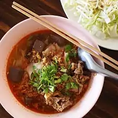 Khao soi Mae Sai, con carne de cerdo (picada) y sangre cuajada, es una variante tailandesa que no contiene leche de coco ni curry, pero utiliza la misma salsa que en nam ngiao.