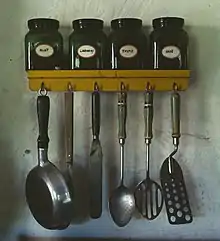 Estante de doble uso: especiero y percha de utensilios de cocina.