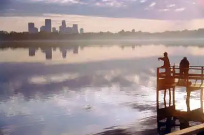 Downtown skyline in view over Bde Maka Ska and its dock