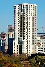 The 31 story building from the south. The building is a rectangular prism with some setbacks on the side facing the viewer.