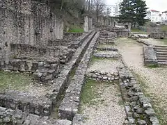 Calle de tiendas sobre el odeon, con la alcantarilla.