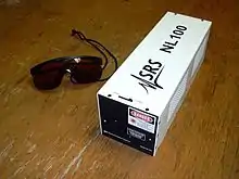 Imagen de una caja metálica blanca, versión comercial del laser de N2 con la inscripción SRS.
