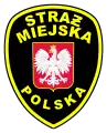 Insignia de la policía municipal polaca (Straż Miejska), utilizando Ƶ barrada como variante de Ż