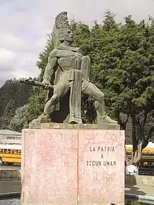 Monumento a Tecún Umán. Mientras pasan en carro por el lugar en que se ubica el monumento, Willy le explica a Paco su versión de cómo murió el héroe guatemalteco.