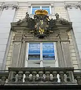 Front portal balustrade, piano nobile windows, and coat of arms