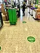 Signs on the Terrazzo floor at the checkout in Coop, Åmål to facilitate social distancing while queuing, as well as plexiglass shields to protect checkout staff from catching the disease.