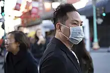 Person wearing a mask in Chinatown, San Francisco, California.
