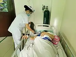 A medical worker attending to a patient at the Ospital ng Sampaloc in Manila