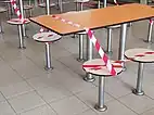 Tables and seats cordoned off with tape