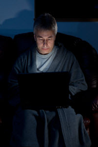 Man up late at night at laptop