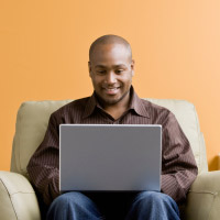 Photo of man using a laptop