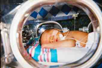 Human infant in incubator