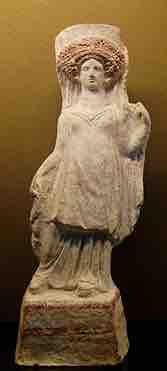 Standing woman holding her veil. Terracotta figurine, c. 400–375 BC