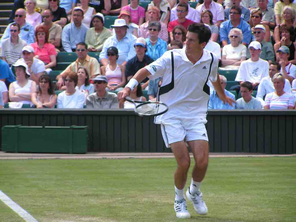Tim Henman performs a backhand volley at the Wimbledon tournament in 2004.