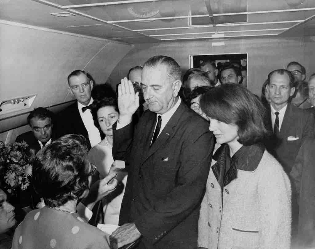 Lydnon B. Johnson, taking the oath of office aboard Air Force 1.